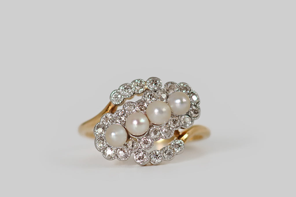 Antique Jewelry Portland, Vintage Jewelry Portland , Antique Engagement Rings | Poor Mouchette | An Edwardian era diamond and pearl cluster ring, modeled in 18k yellow gold and platinum, with an unusual, curving form. The ring face is a serpentine procession of small, bezel-set, old European cut diamonds— these bubbly little platinum bezels sit shoulder-to-shoulder, giving our wavy diamond "line" a sweet, scalloped edge. 