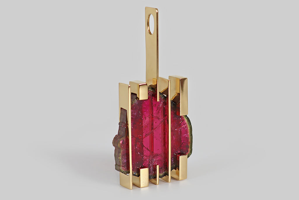 Antique Jewelry Portland, Vintage Jewelry Portland , Antique Engagement Rings | Poor Mouchette | A monumental, one-of-a-kind pendant, fabricated in 18k yellow gold, by the beloved Brazilian design house H. Stern. This striking modernist pendant features an extra-large, raspberry-colored tourmaline slice— this rare specimen is set in a "trapped" manner, using the series of bars that make-up the body of the pendant.