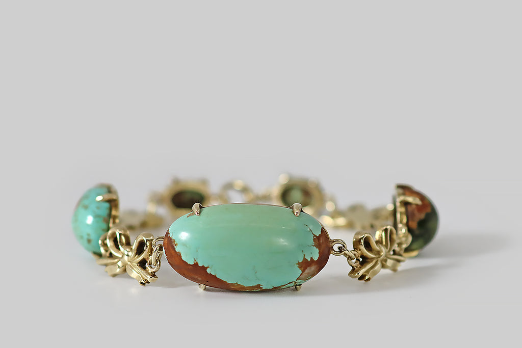 Antique Jewelry Portland, Vintage Jewelry Portland , Antique Engagement Rings | Poor Mouchette | A wonderful, late Victorian link bracelet, modeled in 14k yellow gold, whose five, claw-set, turquoise gems link-up with a series of whimsical bows. These turquoise cabochons are substantial, natural, and untreated— they vary in the manner of specimens, ranging in color from robin's egg blue, to olive green. Each is truly unique and painterly, being beautifully figured with red-brown matrix.