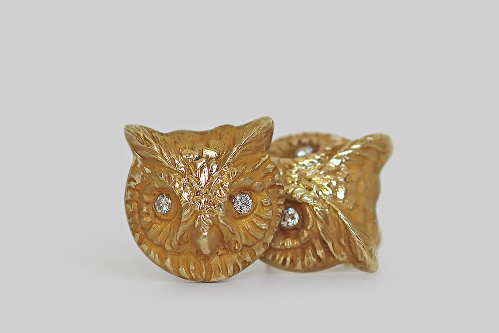 Poor Mouchette | Curated Antique Jewelry, Vintage Jewelry & Engagement Rings | Portland, Oregon | A charming pair of vintage earrings, realistically modeled as screech owl faces, in 14k yellow gold with a rich, high-color bloom. These avian friends are highly dimensional, solidly-cast, and beautifully sculpted, with finely-detailed feathers and calm, watchful expressions. Their eyes are lively, white, round brilliant cut diamonds, set in bezels.