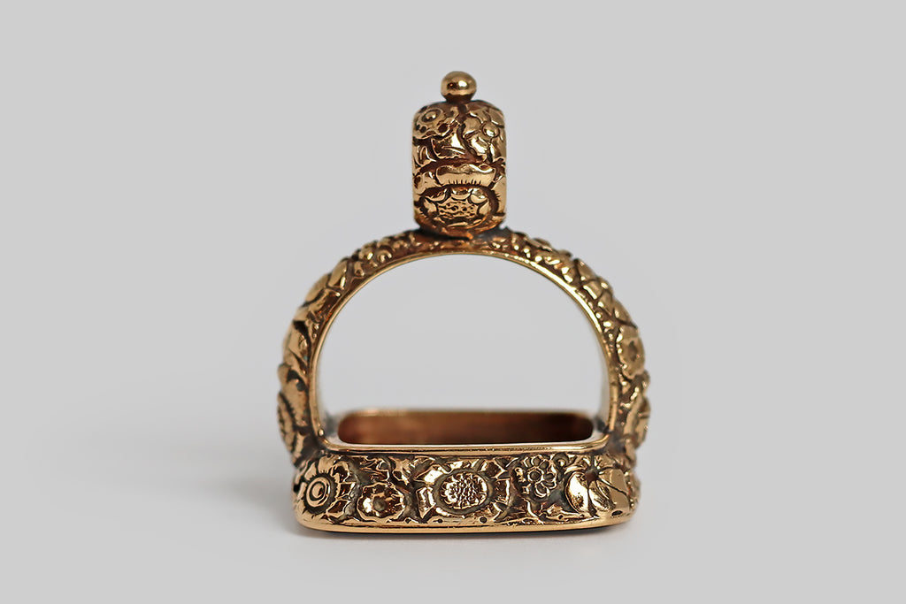 Poor Mouchette | Curated Antique Jewelry, Vintage Jewelry & Engagement Rings | Portland, Oregon | A striking, extra-large, Georgian era fob, modeled in 14k yellow gold and set with a rectangular, intaglio-carved, bloodstone gem. This finely-carved wax seal features a coat of arms, atop which stands a rampant lion. This coat of arms is "impaled" to indicate a marriage. The sinister field is divided, diagonally, "party per bend—" the charge depicted in the top half of this field is an eradicated tree