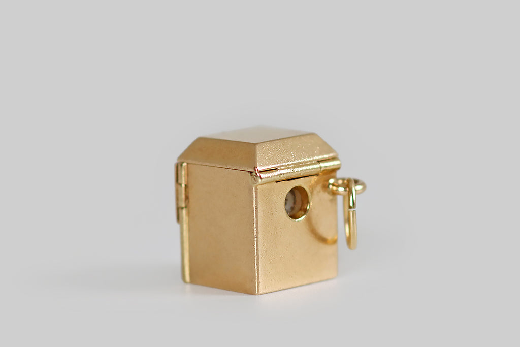 Antique Jewelry Portland, Vintage Jewelry Portland , Antique Engagement Rings | A rare and wonderful, complex, mid 20th century charm, modeled as a record player, in 14k yellow gold. This miniature record player is housed an old-school cabinet, whose dust cover and small, front-facing doors all open and close! It is complete with a tiny gold arm, a glossy black enamel record, and a series of cheerful, rainbow-colored bars