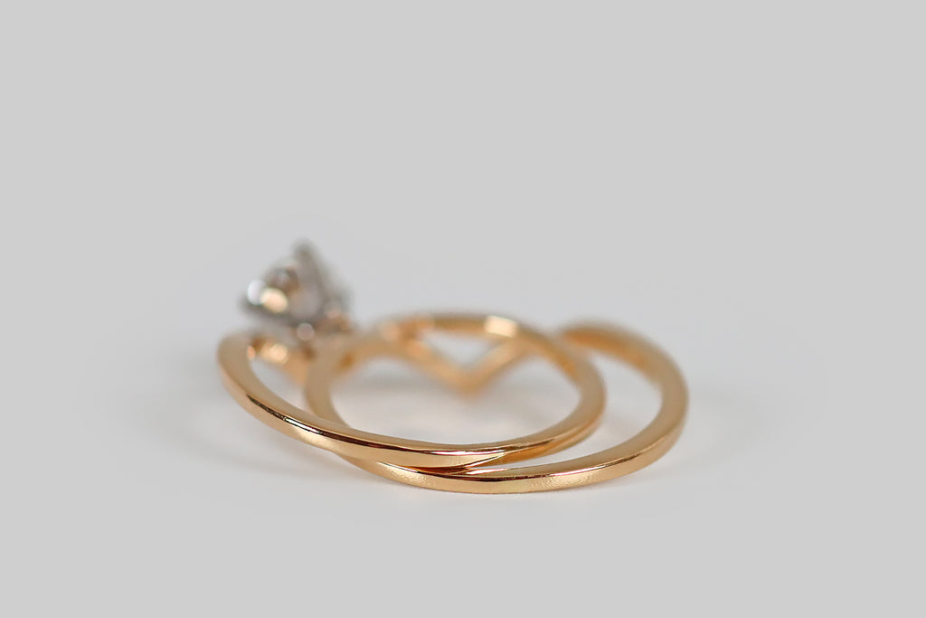 Poor Mouchette | Curated Antique Jewelry, Vintage Jewelry & Engagement Rings | A very cool, 1970s, chevron-shaped engagement ring and wedding band set, modeled in 18k yellow and white gold by Jabel. The engagement ring half of this duo features a sparkling round brilliant cut diamond (G, VS2) that is held in a four prong, white gold basket.