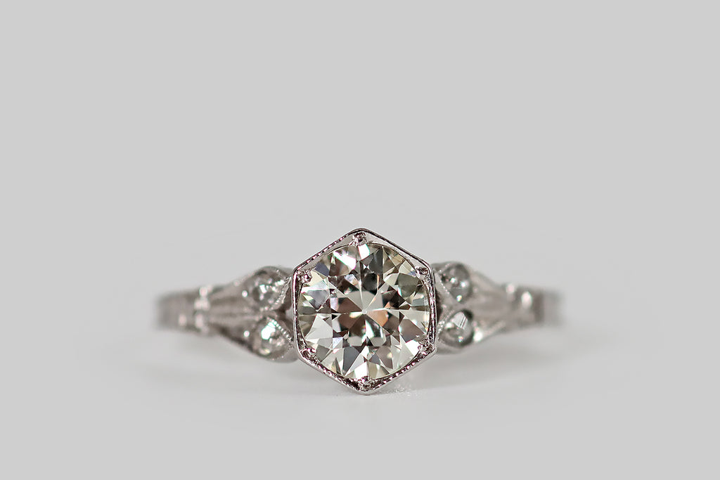 Antique Jewelry Portland, Vintage Jewelry Portland , Antique Engagement Rings | Poor Mouchette | An elegant, Art Deco era solitaire, modeled in platinum, whose primary gem is a very sparkly, white-facing, 3/4 carat old European cut diamond. This wonderful hand-cut diamond is seated in a low-profile, milgrained, hexagonal bezel, where it is held in place by six beaded prongs. It is flanked by the long pairs of leaves that comprise the ring's cathedral shoulders
