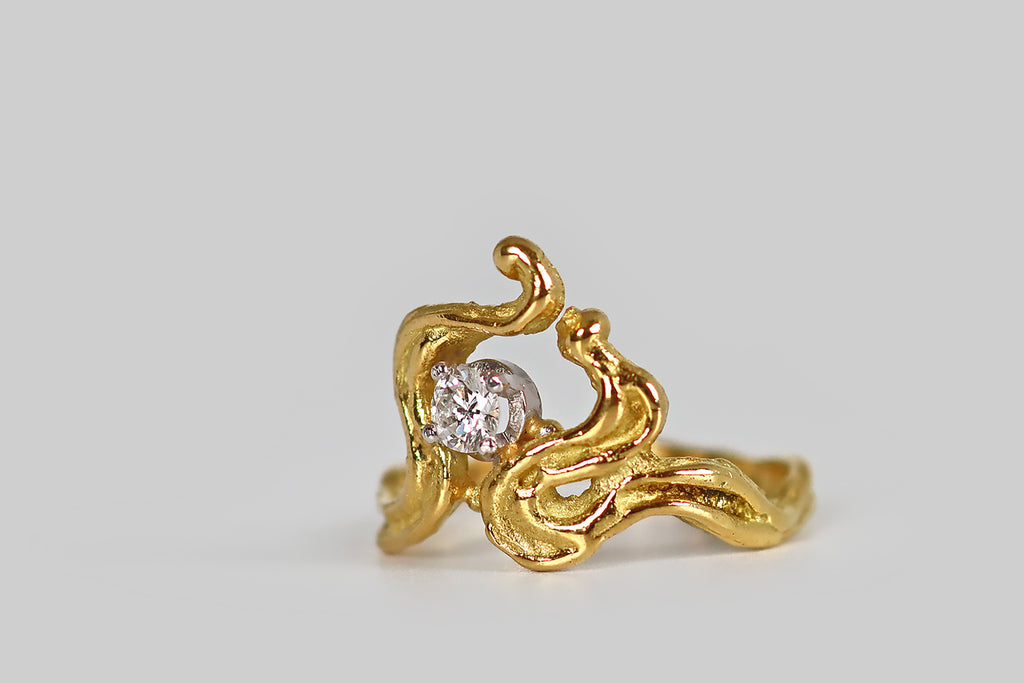 Antique Jewelry Portland, Vintage Jewelry Portland , Antique Engagement Rings | Poor Mouchette | A striking, mid-twentieth-century ring, modeled in 18k yellow gold, whose irregular, curling form is suggestive of flames. These graceful, meandrous forms bend, curl, and rise to create the ring's sculptural face. A sparkling, round brilliant cut diamond rests off-center, in a four prong basket, where these curvaceous, flame-like lines lean together. We love this ring for its organic movement and its artfully 