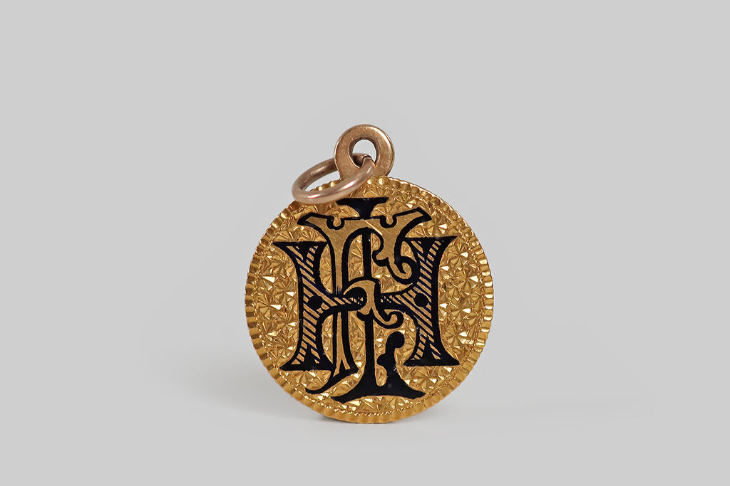 Antique Jewelry Portland, Vintage Jewelry Portland , Antique Engagement Rings | Poor Mouchette | A Victorian era love token pendant, made with a gold coin dated 1878. This $2.50 Liberty coin is 22k gold. One side of the coin has been altered to bear an especially beautiful black enamel monogram (FHL). The blocky, serif letters are done in three styles— the F is outlined, the L is filled in with black, and the H is decorated with diagonal lines and dots. 