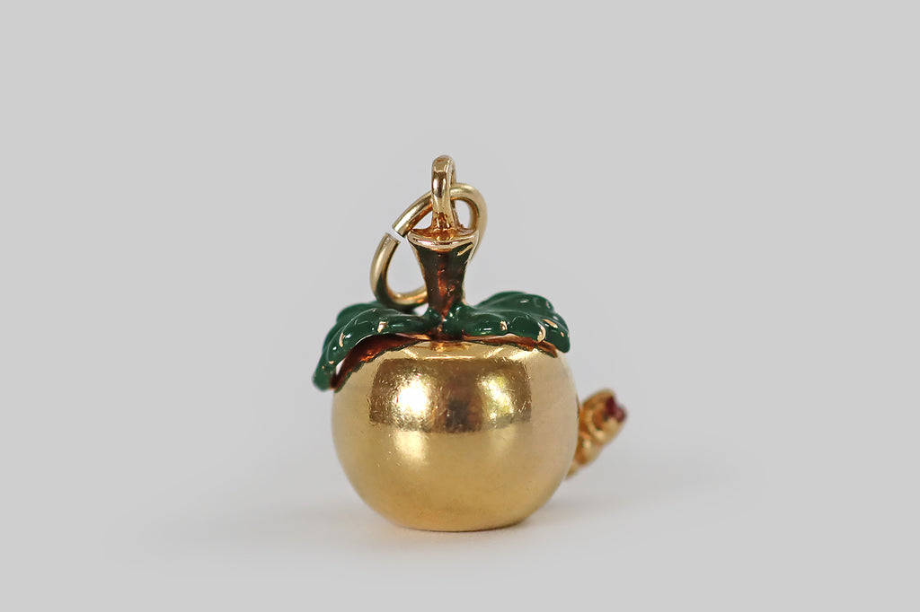 Antique Jewelry Portland, Vintage Jewelry Portland , Antique Engagement Rings | Poor Mouchette | A wonderful vintage enameled charm,&nbsp;modeled in 14k yellow gold, that is made in the form of a beautiful apple, with a naughty worm at its base! This miniature apple has a smooth, buttery, time-won sheen. Its green enameled leaves drape over its shoulders. The little worm at the base of the apple eats its way through the fruit