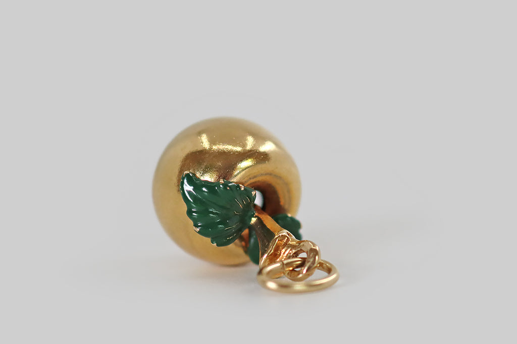 Antique Jewelry Portland, Vintage Jewelry Portland , Antique Engagement Rings | Poor Mouchette | A wonderful vintage enameled charm,&nbsp;modeled in 14k yellow gold, that is made in the form of a beautiful apple, with a naughty worm at its base! This miniature apple has a smooth, buttery, time-won sheen. Its green enameled leaves drape over its shoulders. The little worm at the base of the apple eats its way through the fruit
