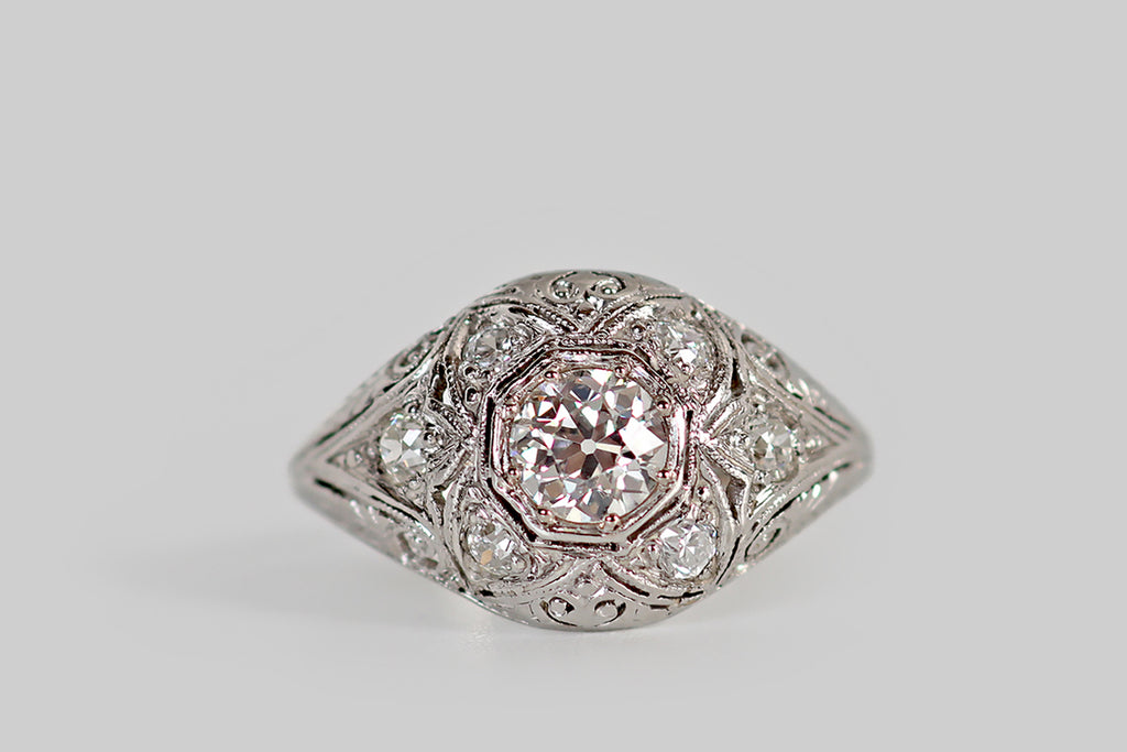 Poor Mouchette | Curated Antique Jewelry, Vintage Jewelry & Engagement Rings | Portland, Oregon | An early Art Deco era, diamond cluster ring, with a low, domed profile, whose primary gem is a .46 carat old European cut diamond. This primary diamond is bead-set into an octagonal seat, where it is surrounded by a bevy of old cut supporters. Four diamonds, in lobe-shaped seats, flank the primary stone, creating the impression of a quatrefoil.