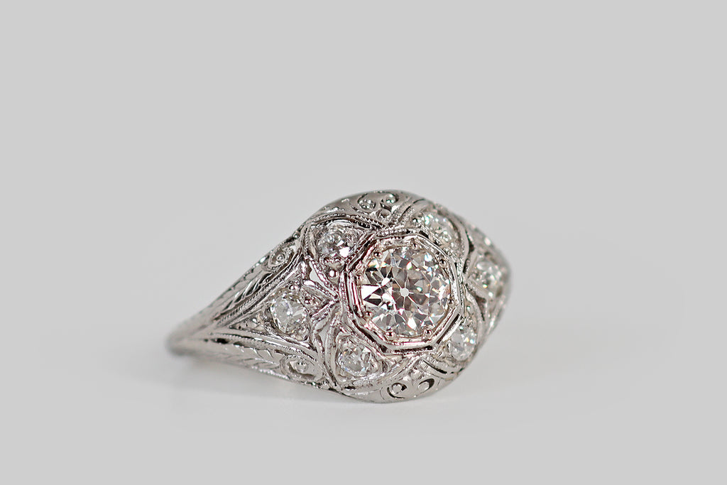 Poor Mouchette | Curated Antique Jewelry, Vintage Jewelry & Engagement Rings | Portland, Oregon | An early Art Deco era, diamond cluster ring, with a low, domed profile, whose primary gem is a .46 carat old European cut diamond. This primary diamond is bead-set into an octagonal seat, where it is surrounded by a bevy of old cut supporters. Four diamonds, in lobe-shaped seats, flank the primary stone, creating the impression of a quatrefoil.