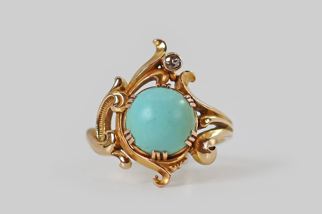 Poor Mouchette | Curated Antique Jewelry, Vintage Jewelry & Engagement Rings | Portland, Oregon | An Art Nouveau era ring, modeled in 14k bloomed yellow gold, whose primary gem is a large, robin's egg blue, Persian turquoise cabochon. This high-dome cab rests in six sets of triple-prongs, where curling, plume-like gold forms appear to bend and swirl around it. At the top of the ring face, and slightly off center, a bezel-set old mine cut diamond floats between two of these plumes.