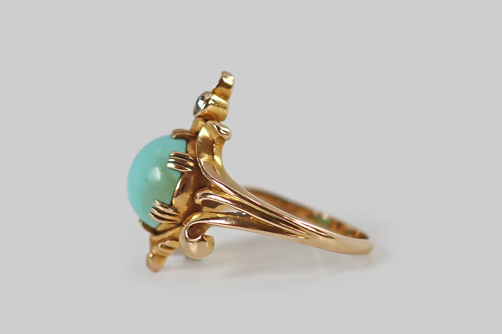 Poor Mouchette | Curated Antique Jewelry, Vintage Jewelry & Engagement Rings | Portland, Oregon | An Art Nouveau era ring, modeled in 14k bloomed yellow gold, whose primary gem is a large, robin's egg blue, Persian turquoise cabochon. This high-dome cab rests in six sets of triple-prongs, where curling, plume-like gold forms appear to bend and swirl around it. At the top of the ring face, and slightly off center, a bezel-set old mine cut diamond floats between two of these plumes.