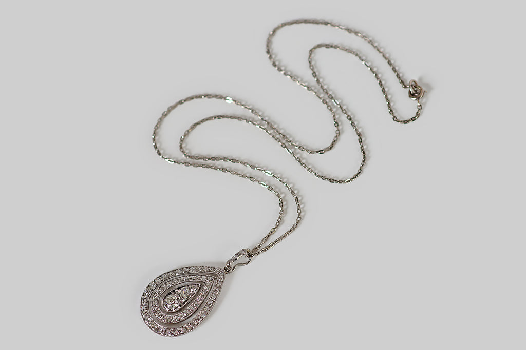 Poor Mouchette | Curated Antique Jewelry, Vintage Jewelry & Engagement Rings | An elegant, Art Deco era, diamond-set pendant, modeled in platinum and composed of three, concentric, pear-shaped elements— two open "hoops," and a solid, central panel. These pear-shaped components are kinetic; they swing lightly from side to side and have some gentle play in all directions. The open hoops are bead-set with many small old European cut diamonds