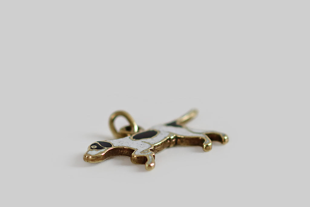 Antique Jewelry Portland, Vintage Jewelry Portland , Antique Engagement Rings | Poor Mouchette | A rare and wonderful Art Deco era charm, modeled in 14k yellow gold, depicting a handsome pointer dog, in a pointing posture. This flat-lay charm is illustrative in style— the dog's form is outlined with polished gold borders, while his body is "filled in" with subtly-speckled white enamel.