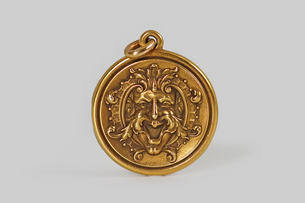 Antique Jewelry Portland, Vintage Jewelry Portland , Antique Engagement Rings | Poor Mouchette | An unusual Art Nouveau era locket, modeled in 14k yellow gold, featuring a laughing, chimeric mascaron face, rendered in highly-detailed, die-struck repoussé. A mascaron is an architectural ornament, traditionally intended to frighten away evil spirits, to keep them from entering buildings.