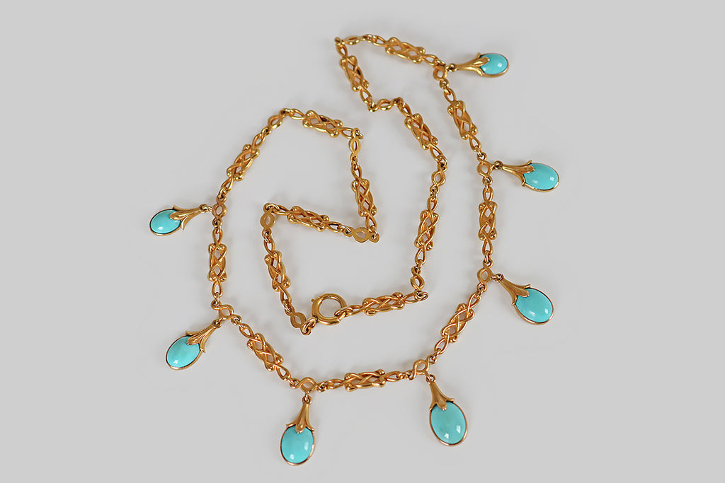 Poor Mouchette | Curated Antique Jewelry, Vintage Jewelry & Engagement Rings | An especially lovely, Art Nouveau era fringe necklace, modeled in 14k yellow gold, whose seven drops are set with vibrant, sky-blue, Persian turquoise cabochons. These sweet turquoise berries or buds are crowned with beautifully carved gold calyces.