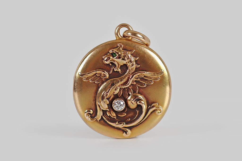Poor Mouchette | Curated Antique Jewelry, Vintage Jewelry & Engagement Rings | Portland, Oregon | A wonderful Art Nouveau era locket, modeled in 14k rosy yellow gold, by the well-known jewelers Whiteside & Blank. This locket is decorated with a beautifully-imagined winged dragon, whose body and tail dissolve into a feathery arrangement of curling plumes. 