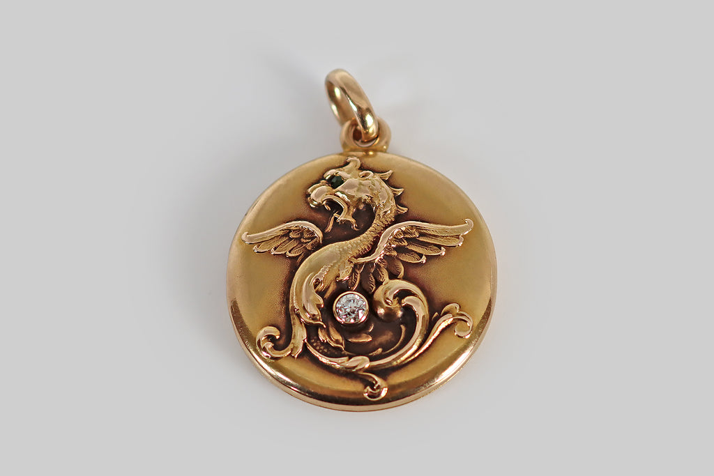 Poor Mouchette | Curated Antique Jewelry, Vintage Jewelry & Engagement Rings | Portland, Oregon | A wonderful Art Nouveau era locket, modeled in 14k rosy yellow gold, by the well-known jewelers Whiteside & Blank. This locket is decorated with a beautifully-imagined winged dragon, whose body and tail dissolve into a feathery arrangement of curling plumes.