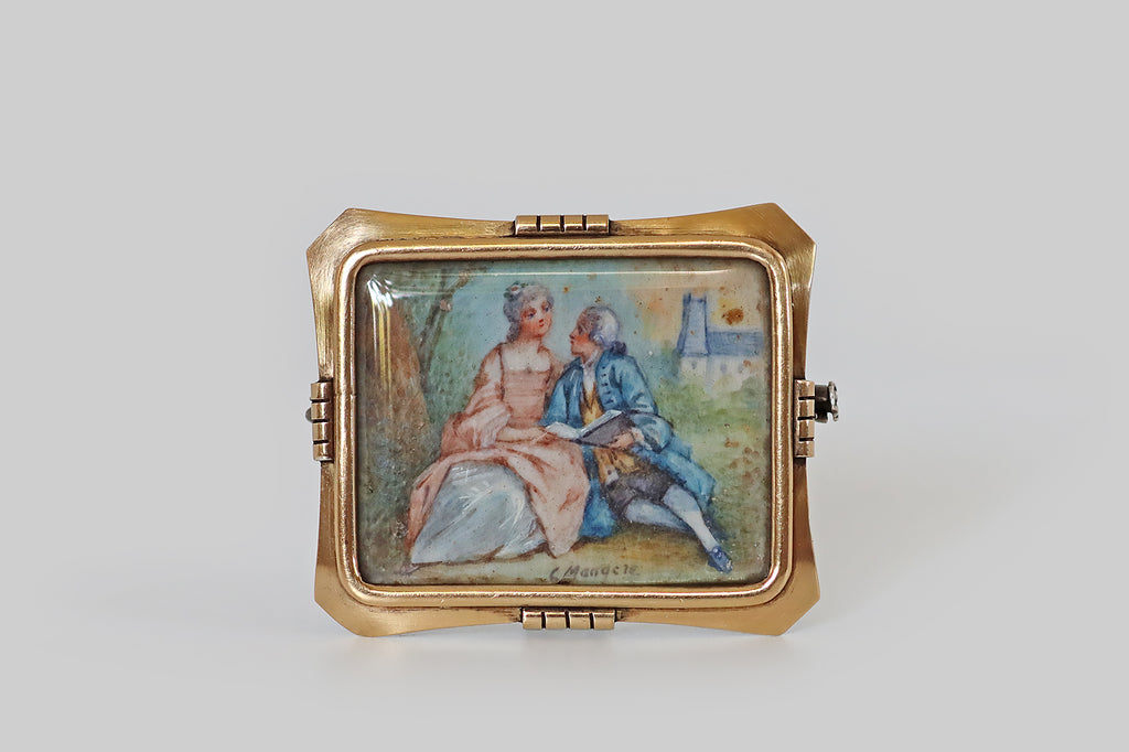 Antique Jewelry Portland, Vintage Jewelry Portland , Antique Engagement Rings | Poor Mouchette | An Arts & Crafts era brooch, imagined as a picture frame, with a 14k gold face, and a sterling silver back. This elegant rectangular frame is gathered at the north, south, east, and west, where it is embellished with notched, clip-like forms. The frames clipped corners are lightly dapped, to add dimensionality. Secure beneath the frame's softly-beveled crystal, a hand-painted watercolor miniature