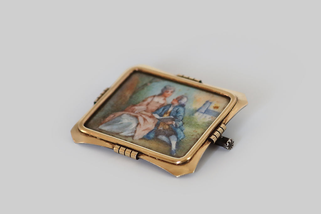 Antique Jewelry Portland, Vintage Jewelry Portland , Antique Engagement Rings | Poor Mouchette | An Arts &amp; Crafts era brooch, imagined as a picture frame, with a 14k gold face, and a sterling silver back. This elegant rectangular frame is gathered at the north, south, east, and west, where it is embellished with notched, clip-like forms. The frames clipped corners are lightly dapped, to add dimensionality. Secure beneath the frame's softly-beveled crystal, a hand-painted watercolor miniature