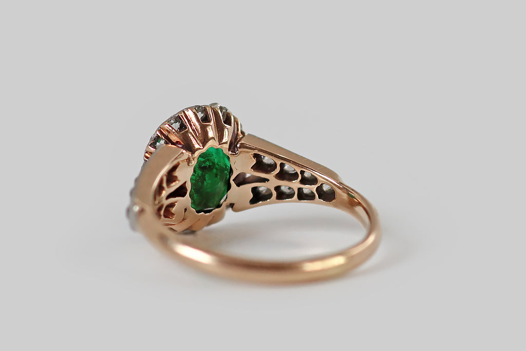 Poor Mouchette | Curated Antique Jewelry, Vintage Jewelry & Engagement Rings | Portland, Oregon | A striking Belle Époque era ring, modeled in 14k rosy yellow gold and platinum, whose primary gem is a natural step-cut emerald, with an especially intense, deep green color! This emerald is faceted in the old style, with a small, low, eight-sided table, and stepped facets that extend from each of its sides.
