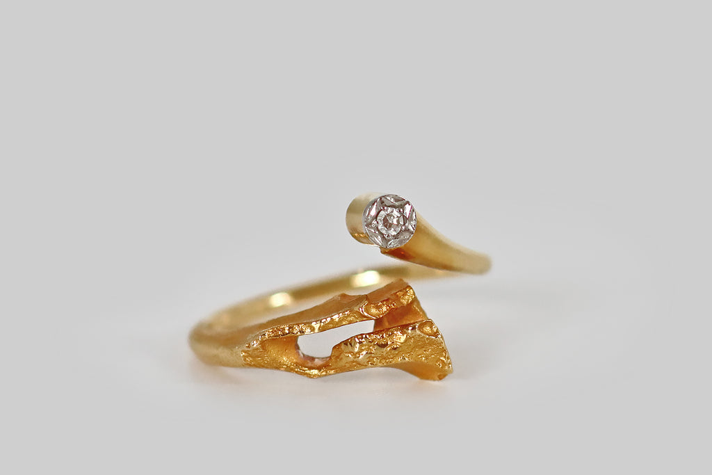 Poor Mouchette | Curated Antique Jewelry, Vintage Jewelry & Engagement Rings | A mid-20th-century, modernist ring, modeled in 18k yellow gold for Lapponia, by the beloved Finnish designer Björn Weckström. This dainty bypass ring was made to resemble a comet, or shooting star. The tail of this comet is broader than the head— naturalistic and sculptural, it features organic textures, a high-color matte finish, and craggy, openwork areas. 