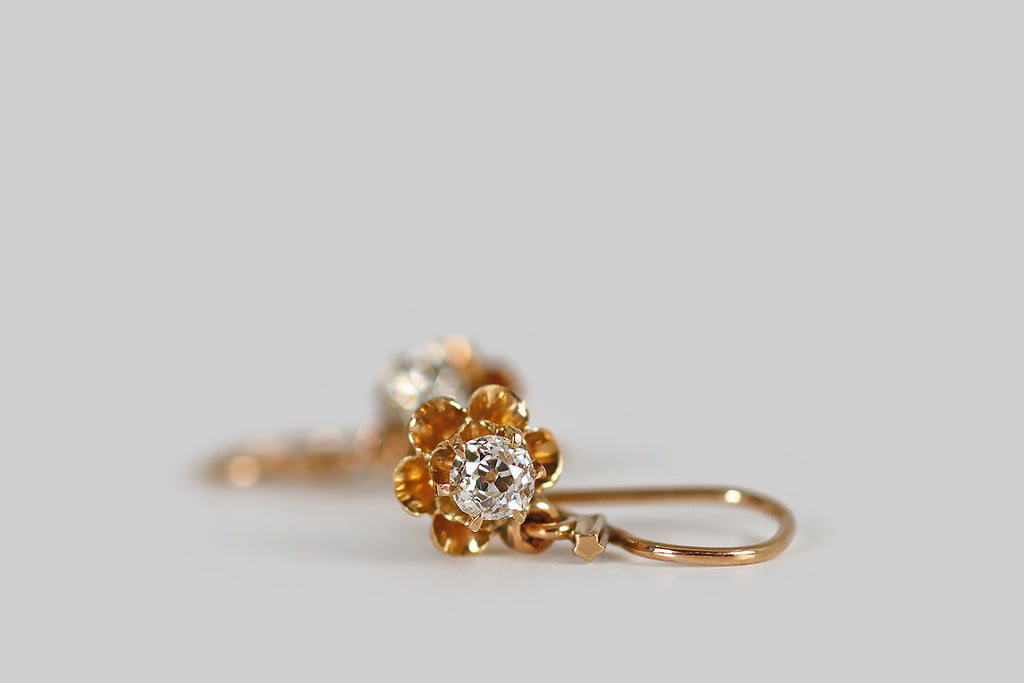 Antique Jewelry Portland, Vintage Jewelry Portland , Antique Engagement Rings | Poor Mouchette | A very sweet pair of Victorian-era drop earrings, modeled in 14k rosy yellow gold, whose buttercup settings hold a pair of chunky, little old mine cut diamonds (approx .33 carats, together), in claw-like prongs. Our diamond-set buttercups hang from locking, kidney-shaped earwires. 