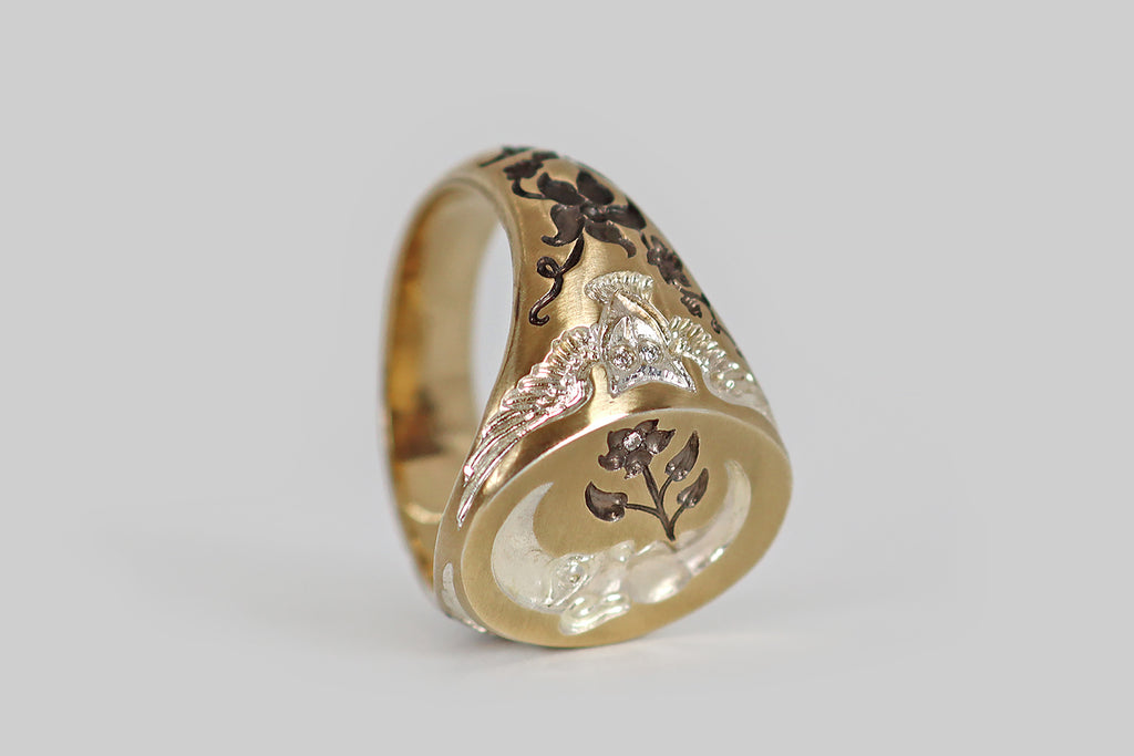 Antique Jewelry Portland, Vintage Jewelry Portland , Antique Engagement Rings | Poor Mouchette | A contemporary signet ring, modeled in 9k yellow gold and hand-engraved by the artist Castro Smith. This ring features a moon and owl motif— a crescent-shaped man-in-the-moon graces the ring face, his cheeks puffed out as if to blow a bubble, but instead he "blows" a moonflower! Flanking the moon, a pair of owls, with outstretched wings, decorate the ring's shoulders