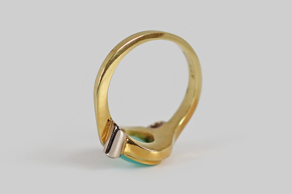 Poor Mouchette | Curated Antique Jewelry, Vintage Jewelry & Engagement Rings | A late vintage ring, modeled in 18k yellow and white gold, whose character is defined by the fluid, satiny, sash-like forms that cradle the ring's central, chrysoprase cabochon. This glowing, oval chrysoprase is held in the modified-bezel these curving yellow-gold forms create. Astride it (to the SE and NW) a pair of sparkling, RBC diamonds