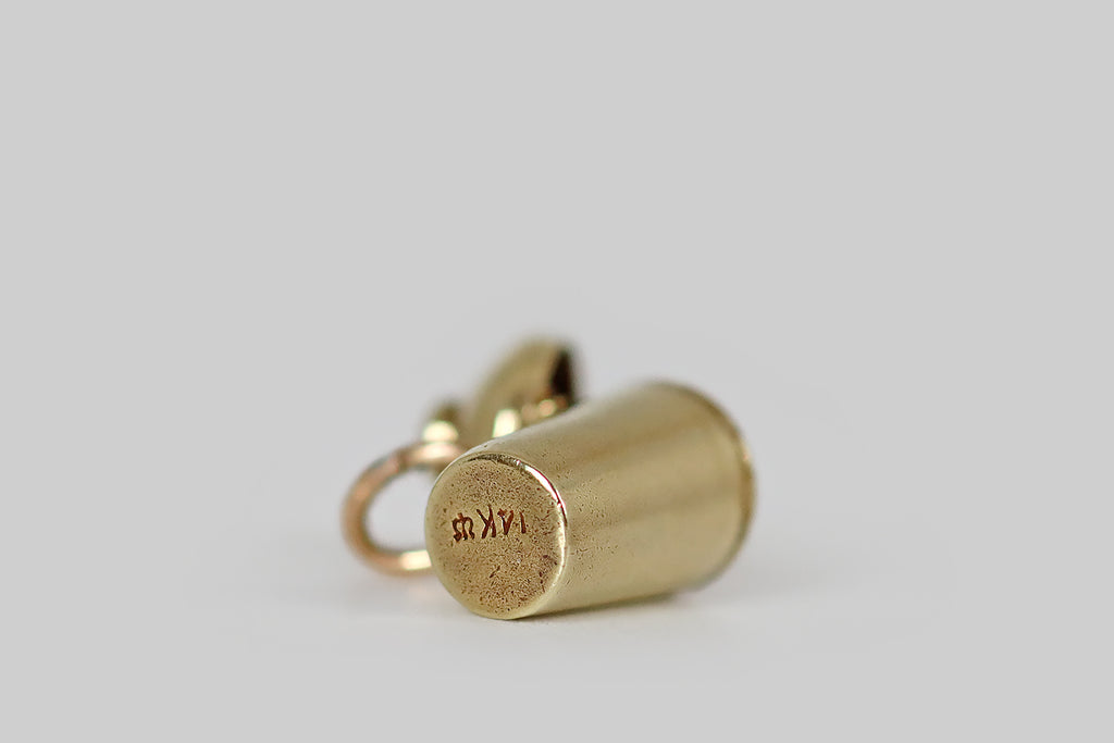 Poor Mouchette | Curated Antique Jewelry, Vintage Jewelry & Engagement Rings | Portland, Oregon |A dainty, vintage, articulated charm, made in 14k yellow gold by the well-known New York jewelers Sloan & Co. This little charm is made to resemble a cocktail shaker, with a hinged lid. Open the lid, and a tiny satan rises up from within! This little devil wears a devious expression, and a pointed, upturned mustache, along with his diabolical "horns."