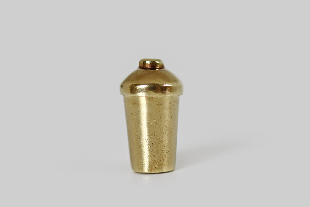 Poor Mouchette | Curated Antique Jewelry, Vintage Jewelry & Engagement Rings | Portland, Oregon |A dainty, vintage, articulated charm, made in 14k yellow gold by the well-known New York jewelers Sloan & Co. This little charm is made to resemble a cocktail shaker, with a hinged lid. Open the lid, and a tiny satan rises up from within! This little devil wears a devious expression, and a pointed, upturned mustache, along with his diabolical "horns."