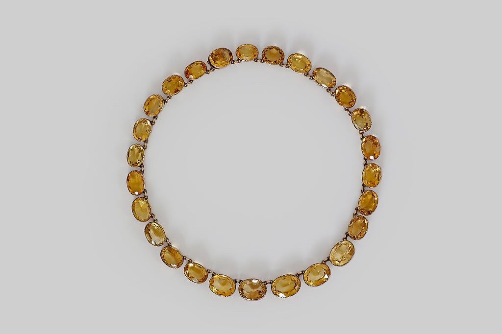 Poor Mouchette | Curated Antique Jewelry, Vintage Jewelry & Engagement Rings | Portland, Oregon | A wonderful Georgian era riviere necklace, modeled in 14k rose gold, whose "river" of gemstones is a graduating series of faceted oval citrines. These citrines are mounted in hand-fabricated, open-back collets, where they are further secured by eight small prongs.