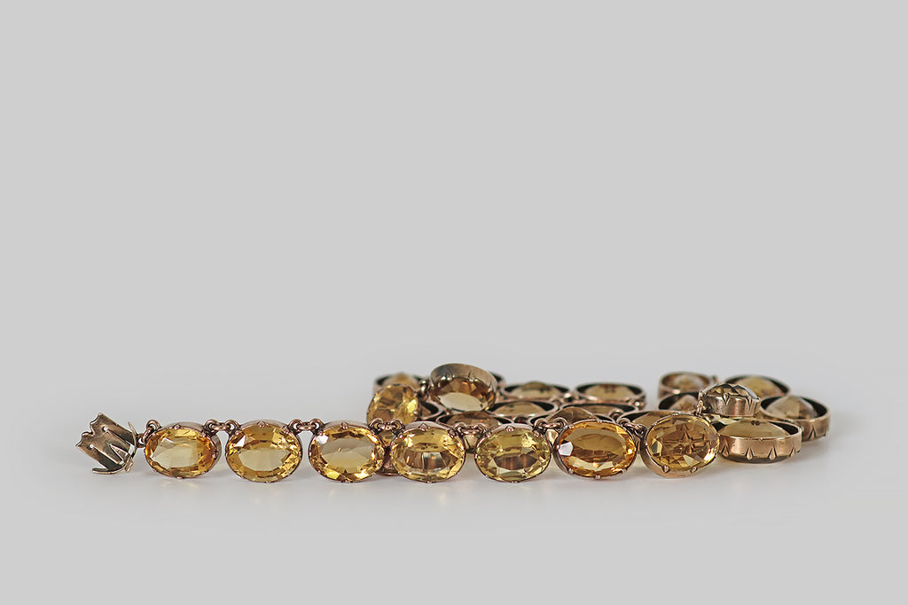 Poor Mouchette | Curated Antique Jewelry, Vintage Jewelry & Engagement Rings | Portland, Oregon | A wonderful Georgian era riviere necklace, modeled in 14k rose gold, whose "river" of gemstones is a graduating series of faceted oval citrines. These citrines are mounted in hand-fabricated, open-back collets, where they are further secured by eight small prongs.
