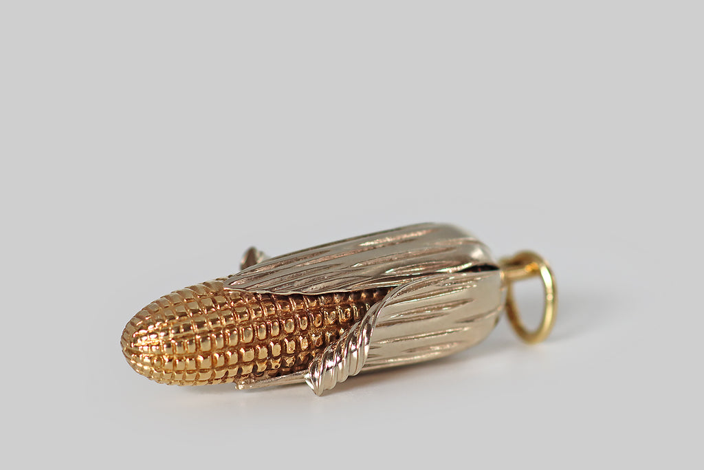Antique Jewelry Portland, Vintage Jewelry Portland , Antique Engagement Rings | Poor Mouchette |A very cool, extra-large, mid-twentieth-century pendant, modeled in 14k yellow and white gold to resemble an ear of corn, with its husk partly peeled back! This ear of corn was made with incredible attention to detail— the yellow gold cob is covered with crisp, high-relief kernels that graduate in size, while the white gold husk is smooth and polished