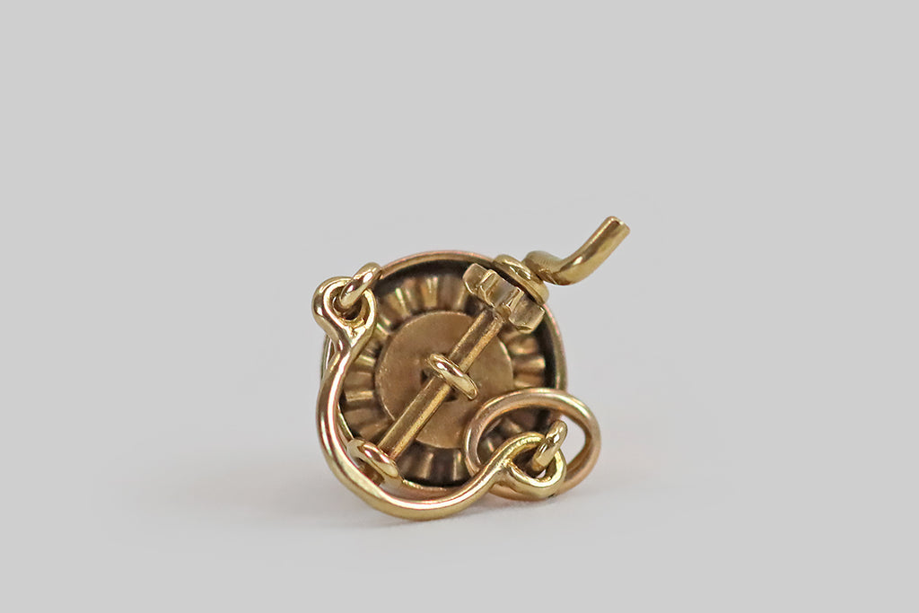 Antique Jewelry Portland, Vintage Jewelry Portland , Antique Engagement Rings | Poor Mouchette | A very rare, miniature, mechanical ice cream maker charm, modeled in 14k gold by the well-known New York jewelers Sloan & Co. This tiny, realistic, bucket-style ice cream maker is made with two rotating, hand-fabricated gears, just like the real thing. The larger gear fits perfectly inside the bucket's opening, while the smaller is attached to the ice cream maker's hand crank
