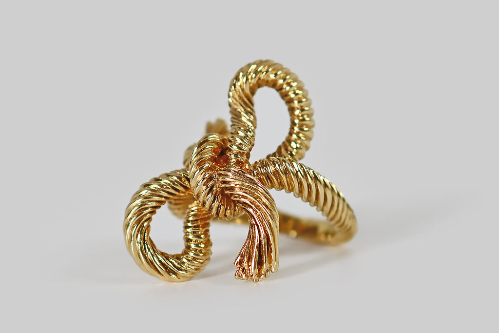 Antique Jewelry Portland, Vintage Jewelry Portland , Antique Engagement Rings | Poor Mouchette | A wonderful vintage 1970s ring, modeled in 18k yellow gold, by the designer Kurt Wayne. This weighty, figural ring takes the form of a length of rope or heavy string, tied into a casual two-loop knot— the ring is made to look like the rope has been tied around the wearer's finger.