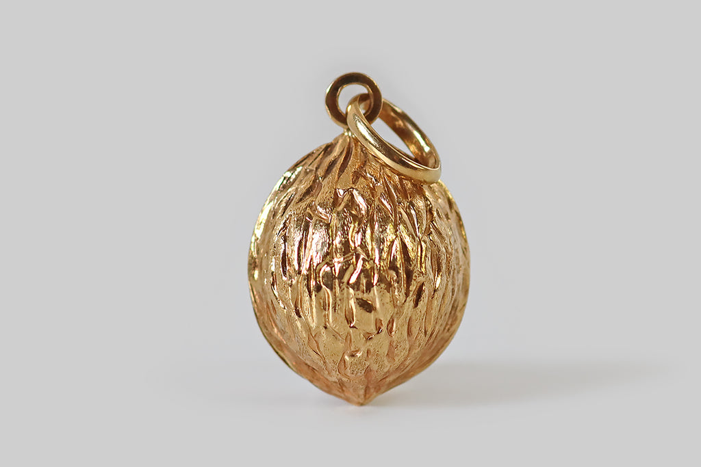Poor Mouchette | Curated Antique Jewelry, Vintage Jewelry & Engagement Rings | Portland, Oregon | A very cool mid-twentieth-century walnut pendant or large charm, modeled in 18k yellow gold. This walnut is realistically textured, with deep, carved-in grooves, and fine, stippled texturing. It hangs from an oversized oval bail. 