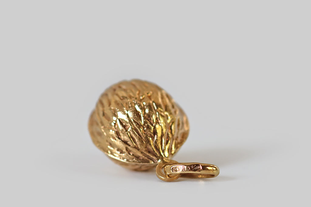 Poor Mouchette | Curated Antique Jewelry, Vintage Jewelry & Engagement Rings | Portland, Oregon | A very cool mid-twentieth-century walnut pendant or large charm, modeled in 18k yellow gold. This walnut is realistically textured, with deep, carved-in grooves, and fine, stippled texturing. It hangs from an oversized oval bail.