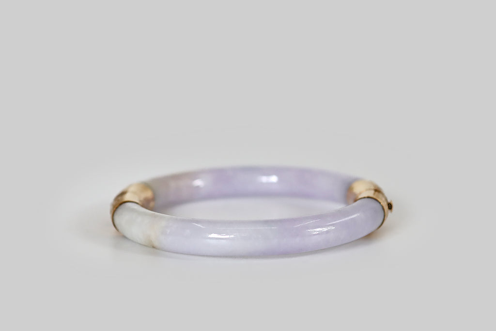 Antique Jewelry Portland, Vintage Jewelry Portland , Antique Engagement Rings | Poor Mouchette | A natural, untreated, lavender jadeite jade bangle, fashioned with an engraved 14k yellow gold hinge and clasp. This jade is a soft and bright lavender color. Its secondary color is cool, muted celadon green, and it is also figured with a single thread of bright green.