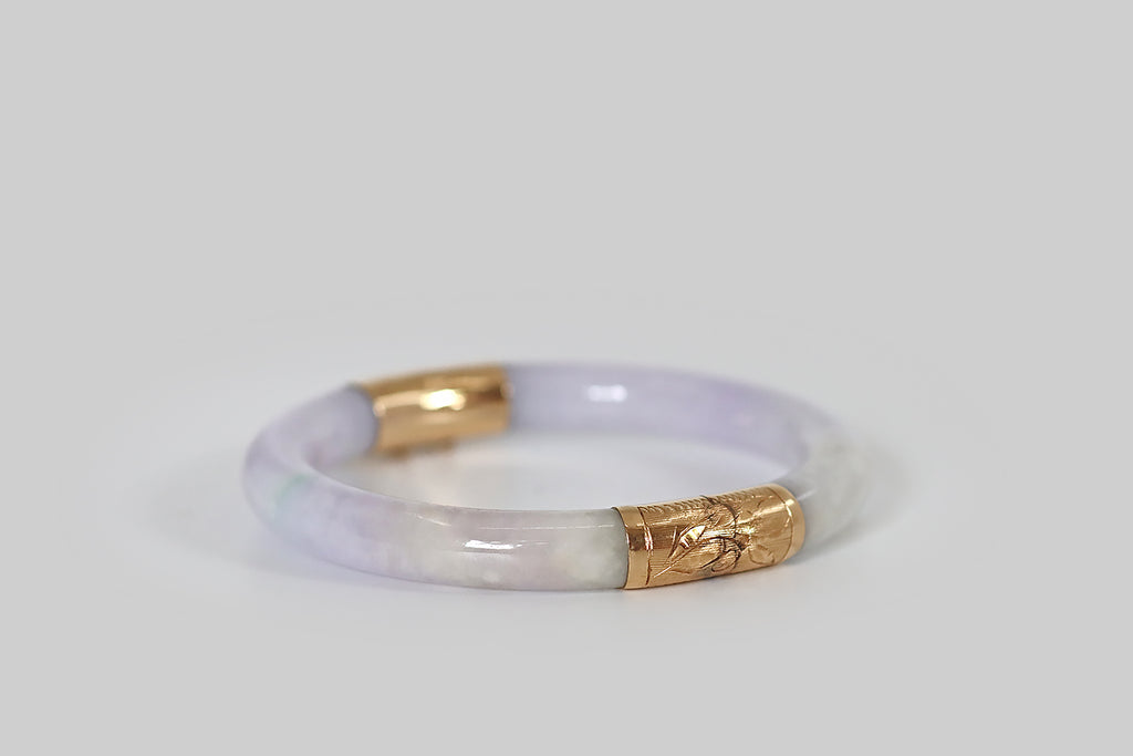 Antique Jewelry Portland, Vintage Jewelry Portland , Antique Engagement Rings | Poor Mouchette | A natural, untreated, lavender jadeite jade bangle, fashioned with an engraved 14k yellow gold hinge and clasp. This jade is a soft and bright lavender color. Its secondary color is cool, muted celadon green, and it is also figured with a single thread of bright green.