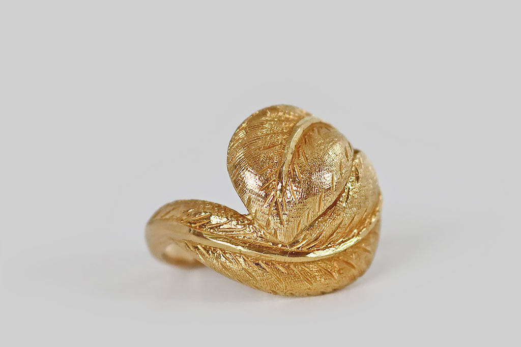Antique Jewelry Portland, Vintage Jewelry Portland , Antique Engagement Rings | Poor Mouchette | A sculptural, late-vintage, bypass-style ring, modeled in 18k yellow gold, whose face is a pair of plump leaves that bow and fold together, embracing the wearer's finger. These broad, ovate leaves are decorated with very fine, hand-engraved details, while the midrib of each leaf is finished with a high polish.