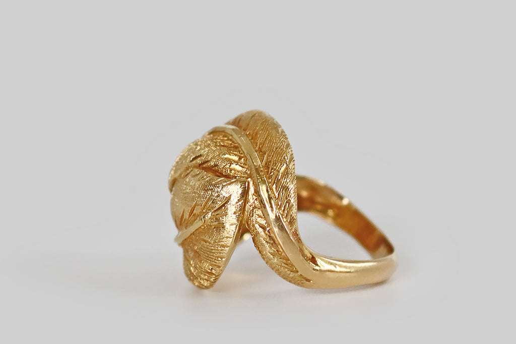 Antique Jewelry Portland, Vintage Jewelry Portland , Antique Engagement Rings | Poor Mouchette | A sculptural, late-vintage, bypass-style ring, modeled in 18k yellow gold, whose face is a pair of plump leaves that bow and fold together, embracing the wearer's finger. These broad, ovate leaves are decorated with very fine, hand-engraved details, while the midrib of each leaf is finished with a high polish.
