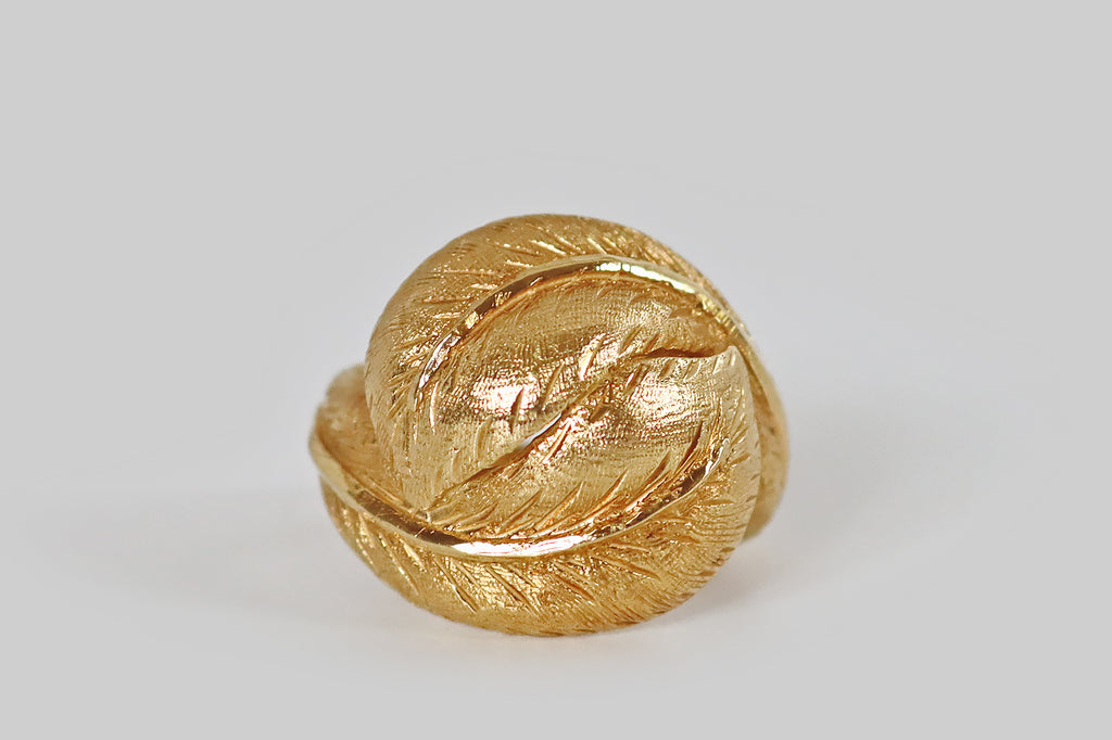 Antique Jewelry Portland, Vintage Jewelry Portland , Antique Engagement Rings | Poor Mouchette | A sculptural, late-vintage, bypass-style ring, modeled in 18k yellow gold, whose face is a pair of plump leaves that bow and fold together, embracing the wearer's finger. These broad, ovate leaves are decorated with very fine, hand-engraved details, while the midrib of each leaf is finished with a high polish.