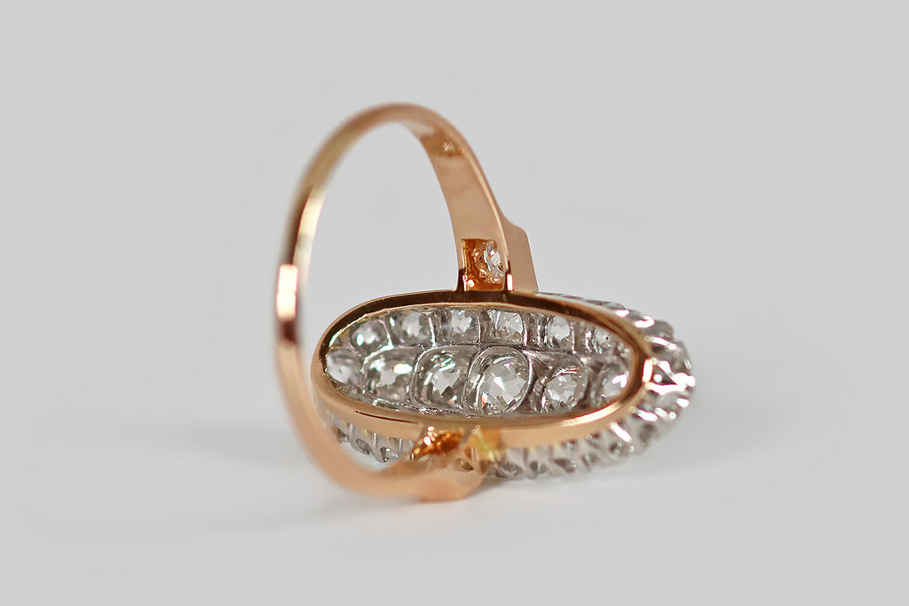 Poor Mouchette | Curated Antique Jewelry, Vintage Jewelry & Engagement Rings | An elegant, low-profile, Edwardian era cluster ring, modeled in 14k rose gold and platinum, whose long oval face is encrusted with 21 chunky, near-colorless, old mine cut diamonds (about 2.55 carats, total). These soulful old diamonds are white and very clean (G/H, VS-SI).
