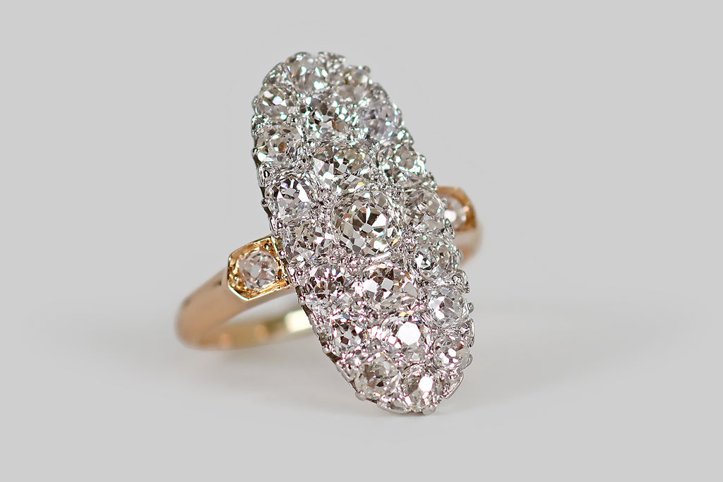 Poor Mouchette | Curated Antique Jewelry, Vintage Jewelry & Engagement Rings | An elegant, low-profile, Edwardian era cluster ring, modeled in 14k rose gold and platinum, whose long oval face is encrusted with 21 chunky, near-colorless, old mine cut diamonds (about 2.55 carats, total). These soulful old diamonds are white and very clean (G/H, VS-SI).