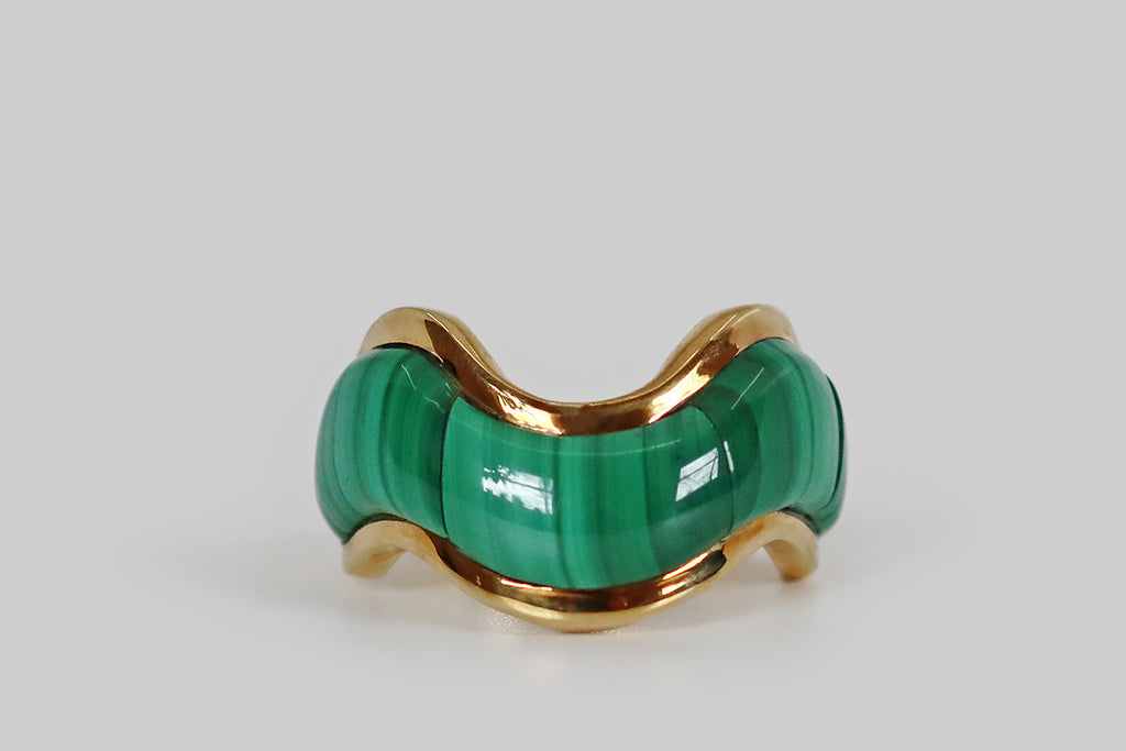 Poor Mouchette | Curated Antique Jewelry, Vintage Jewelry & Engagement Rings | Portland, Oregon | A late vintage ring, modeled in 14k yellow gold, whose curvy, wave-form face is inlaid with three plump malachite cabochons. These carefully cut malachite cabs feature beautiful bright and dark green linear figuring— they appear to be a single swath of striated stone, they fit so seamlessly together! This chubby malachite swath is framed by slender borders of high polished gold. 