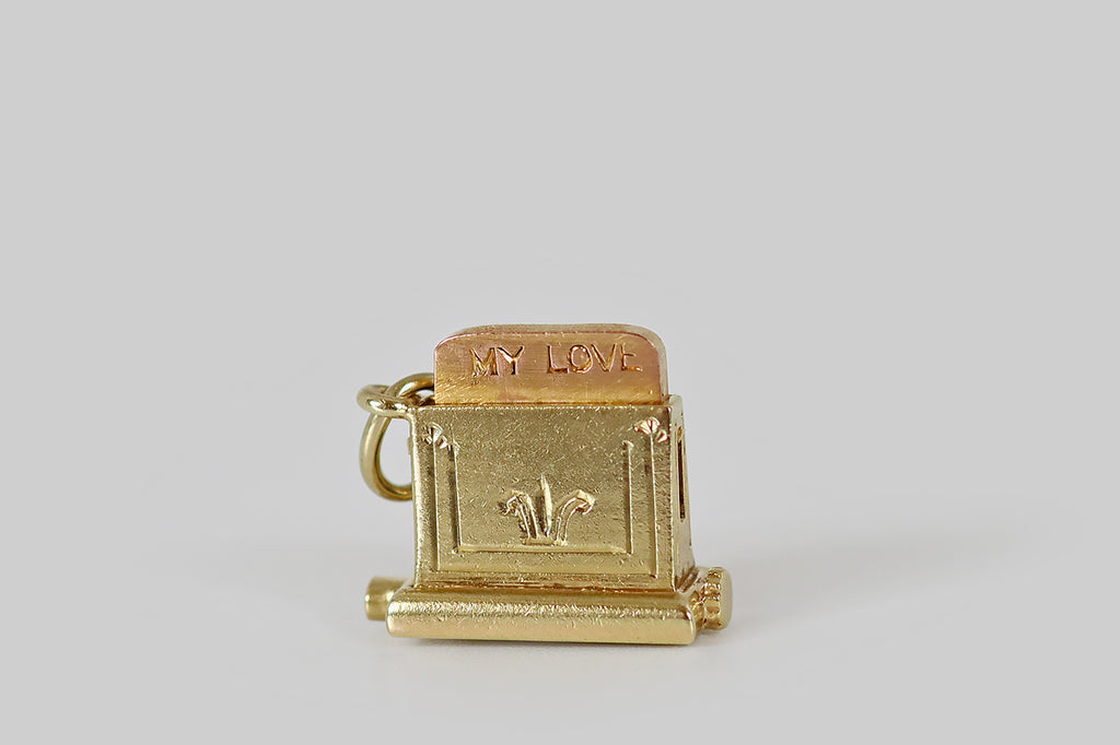 Antique Jewelry Portland, Vintage Jewelry Portland , Antique Engagement Rings | Poor Mouchette | A rare and wonderful Art Deco era charm, modeled after a pop-up toaster, in 14k yellow gold, by the well known New York jewelers Sloan &amp; Co. This miniature toaster is home to a slice of rose gold toast that pops up with the declaration "my love," when a small leaver on the toaster's underside is flicked.