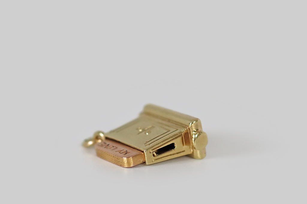 Antique Jewelry Portland, Vintage Jewelry Portland , Antique Engagement Rings | Poor Mouchette | A rare and wonderful Art Deco era charm, modeled after a pop-up toaster, in 14k yellow gold, by the well known New York jewelers Sloan &amp; Co. This miniature toaster is home to a slice of rose gold toast that pops up with the declaration "my love," when a small leaver on the toaster's underside is flicked.
