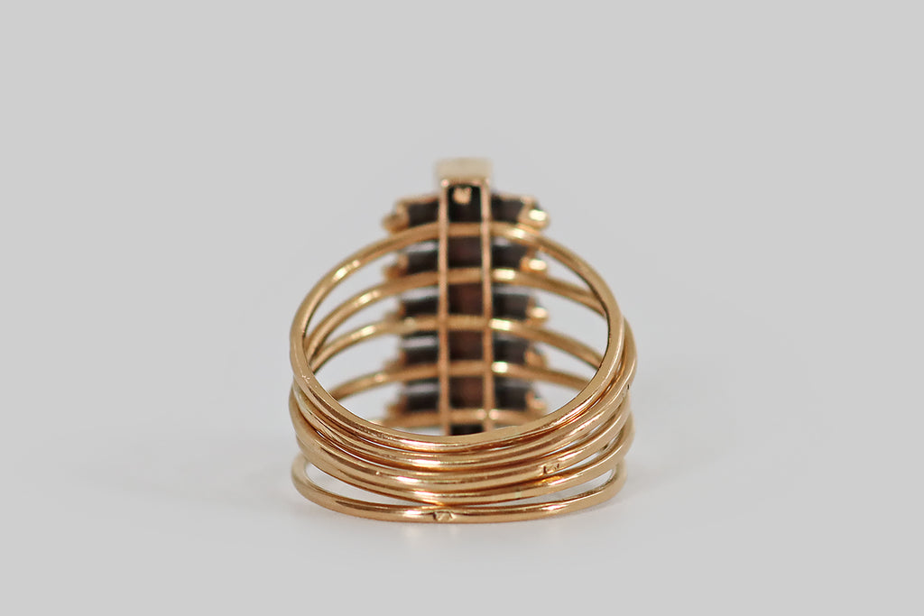 Antique Jewelry Portland, Vintage Jewelry Portland , Antique Engagement Rings | Poor Mouchette | A very cool Victorian era harem ring, modeled in 14k rosy yellow gold, whose elongated, diamond-set face moves freely across a series of five slender, fully-round bands. The ring's mobile face features a long, rectangular plaque, bead-set with six, white, old mine cut diamonds. Flanking this central plaque are ten, fancy-grey rose cut diamonds— these are bead-set into individual square seats. 