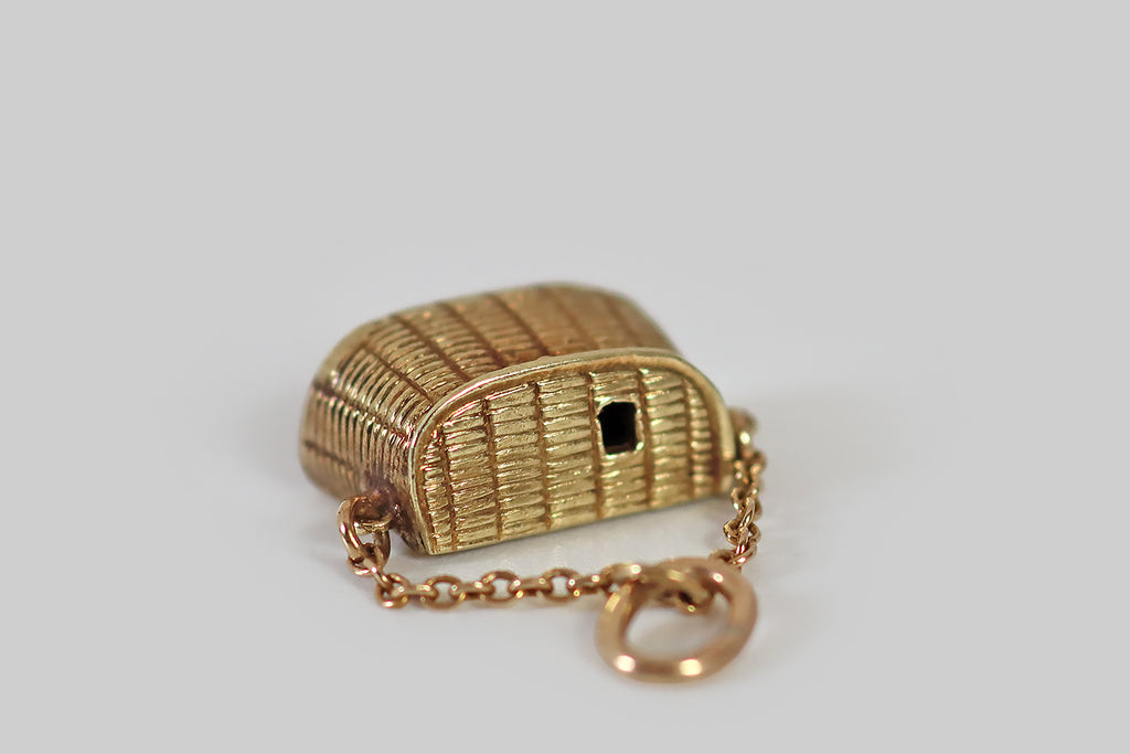 Antique Jewelry Portland, Vintage Jewelry Portland , Antique Engagement Rings | Poor Mouchette | A dainty, vintage, articulated charm, made in 14k yellow gold by the well-known New York jewelers Sloan & Co. This little charm is modeled after a wicker picnic basket— its lid opens to reveal a tiny fish, and a bottle of wine, stored inside! These gold morsels are anchored to the inside of the picnic basket with a fine chain.